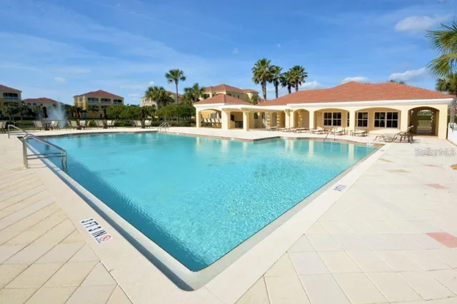 a media room with lots of chairs and a chandelier
