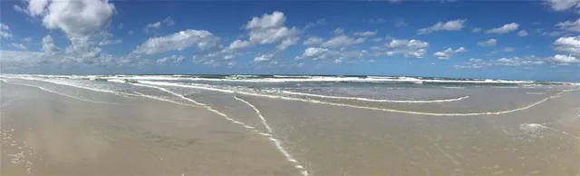 a view of a patio with lawn chairs floor to ceiling window and floor to ceiling window