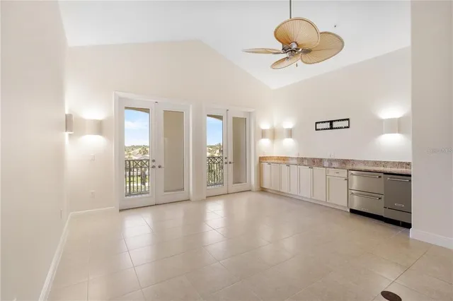 a view of an empty room with wooden floor and windows