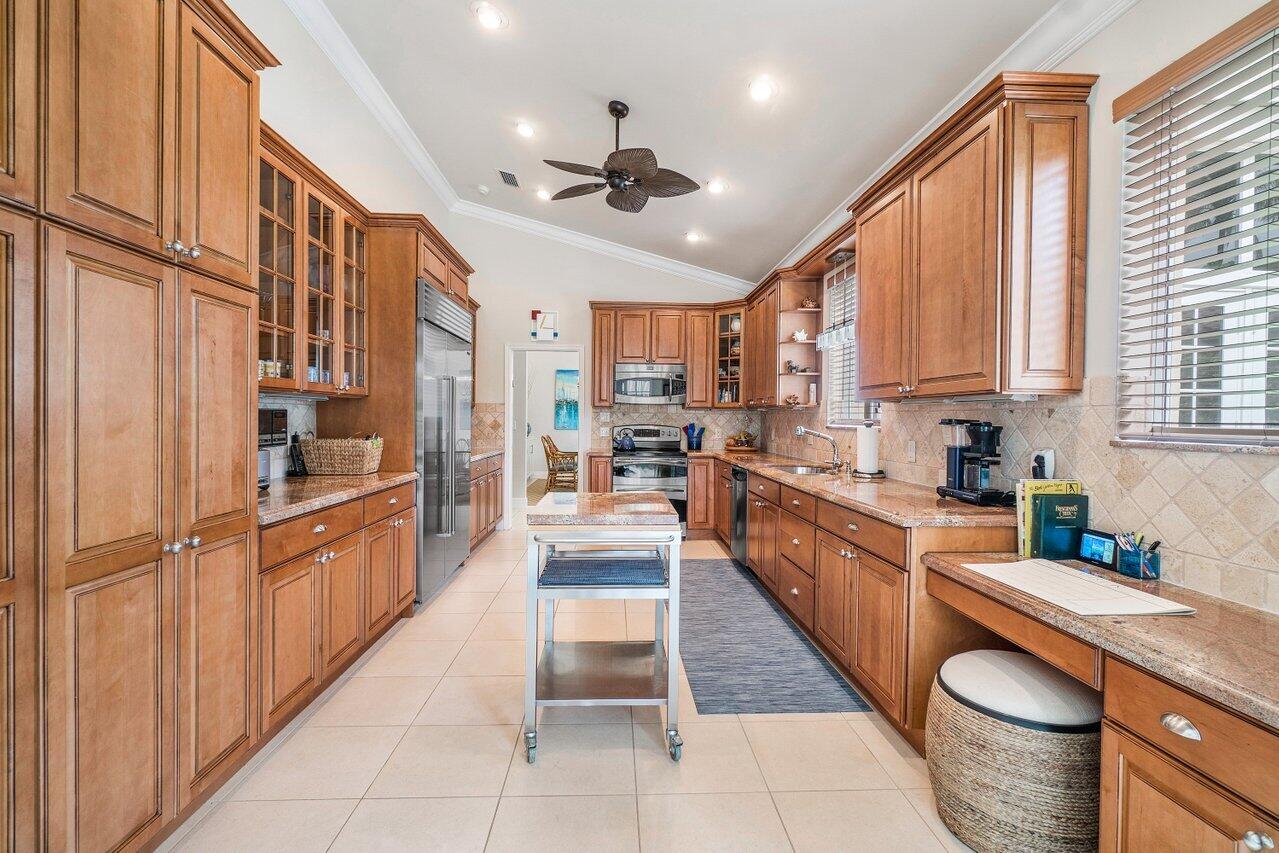 13548 Verde Drive Palm Beach Gardens, FL 33410 - Photo 13 of 43 a large kitchen with stainless steel appliances lots of counter top space