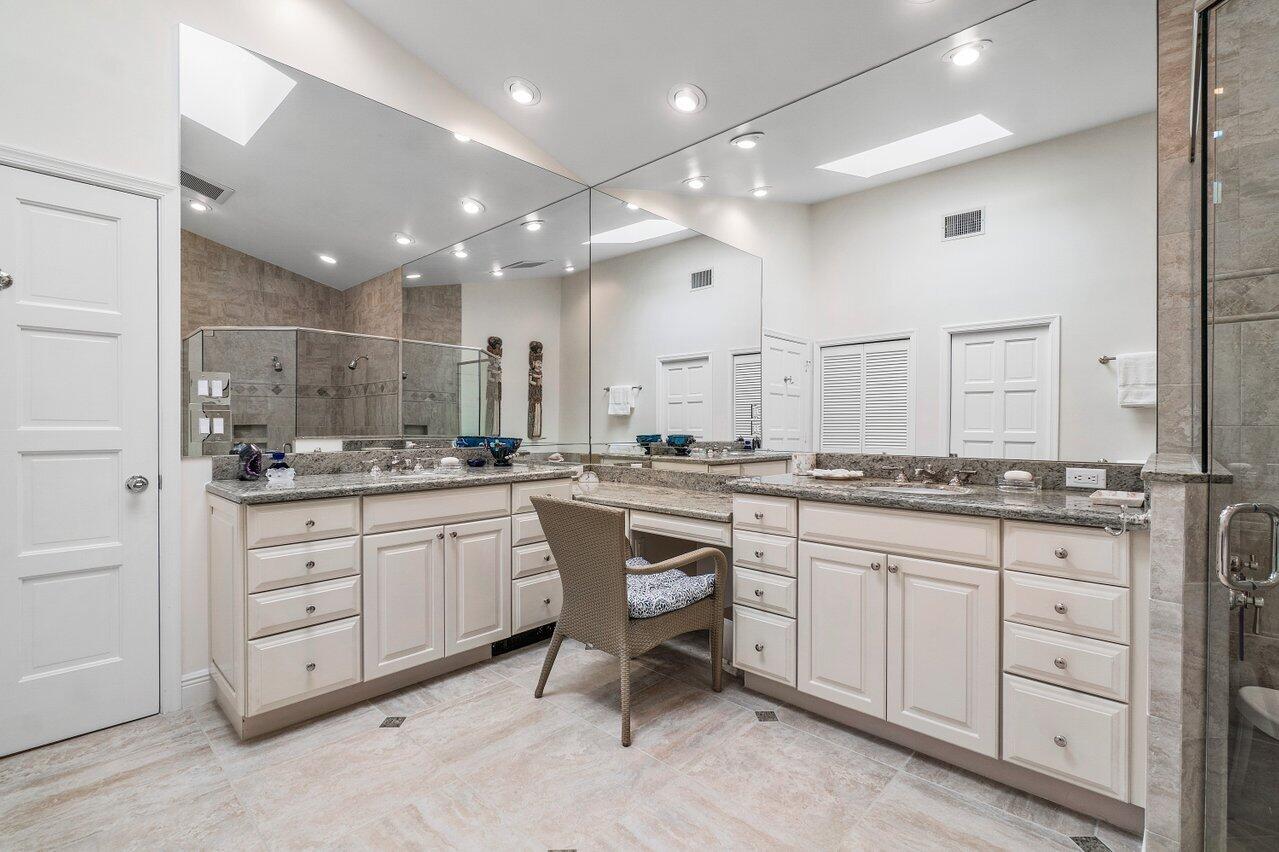 13548 Verde Drive Palm Beach Gardens, FL 33410 - Photo 21 of 43 a large bathroom with a sink and a large mirror