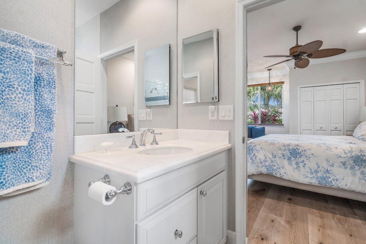13548 Verde Drive Palm Beach Gardens, FL 33410 - Photo 23 of 43 a en suite bathroom with a sink and mirror