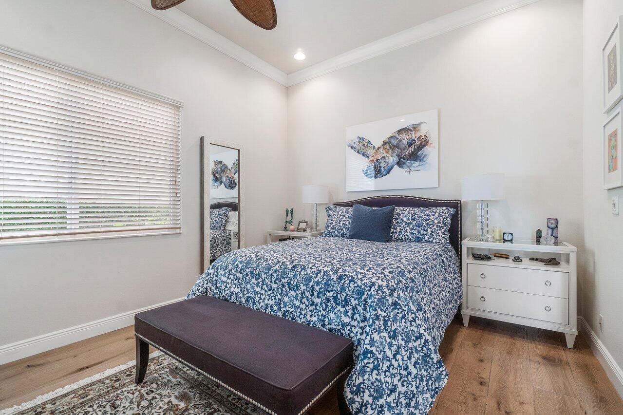 13548 Verde Drive Palm Beach Gardens, FL 33410 - Photo 25 of 43 a room with a bed and a table