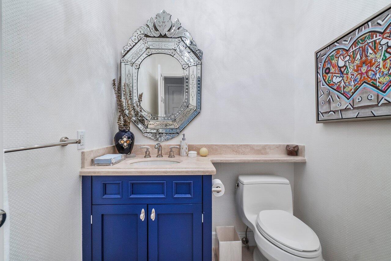 13548 Verde Drive Palm Beach Gardens, FL 33410 - Photo 27 of 43 a bathroom with a toilet sink and mirror