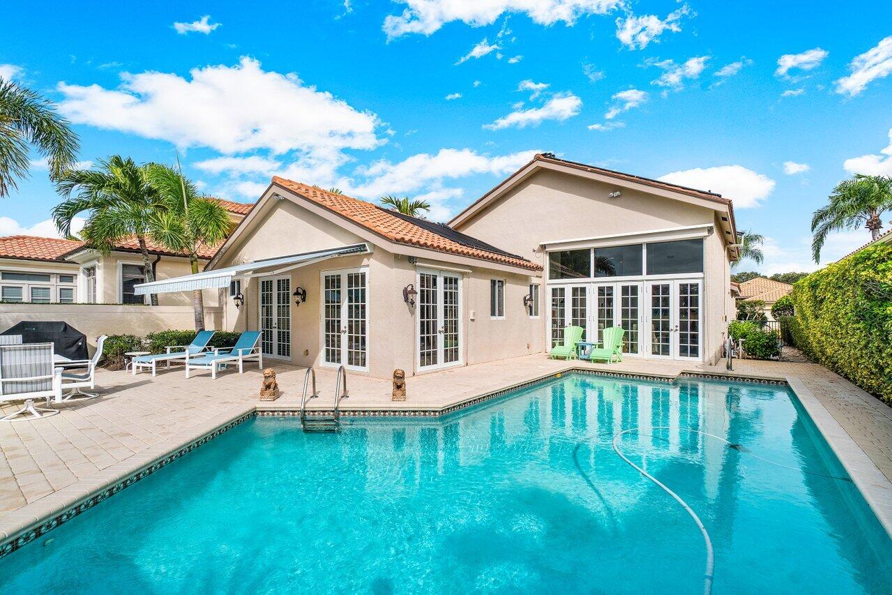 13548 Verde Drive Palm Beach Gardens, FL 33410 - Photo 30 of 43 a view of a house with a yard porch and sitting area