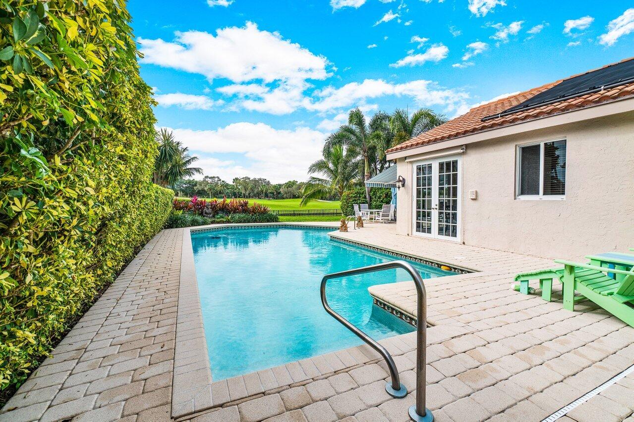 13548 Verde Drive Palm Beach Gardens, FL 33410 - Photo 32 of 43 a view of swimming pool with a patio