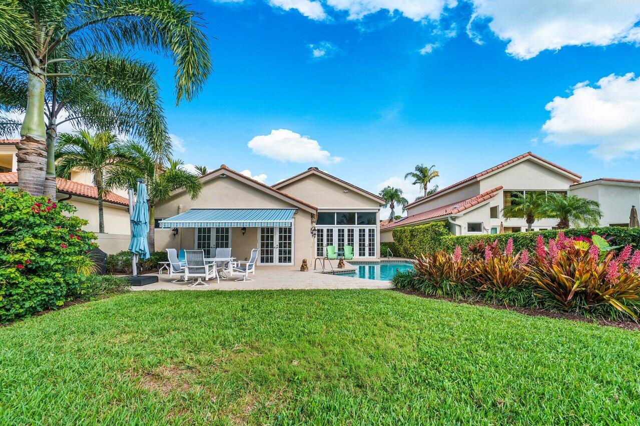 13548 Verde Drive Palm Beach Gardens, FL 33410 - Photo 33 of 43 a front view of a house with garden
