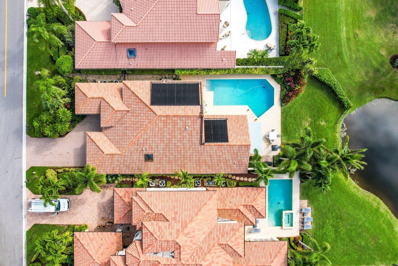 13548 Verde Drive Palm Beach Gardens, FL 33410 - Photo 36 of 43 an aerial view of a house with a yard and potted plants