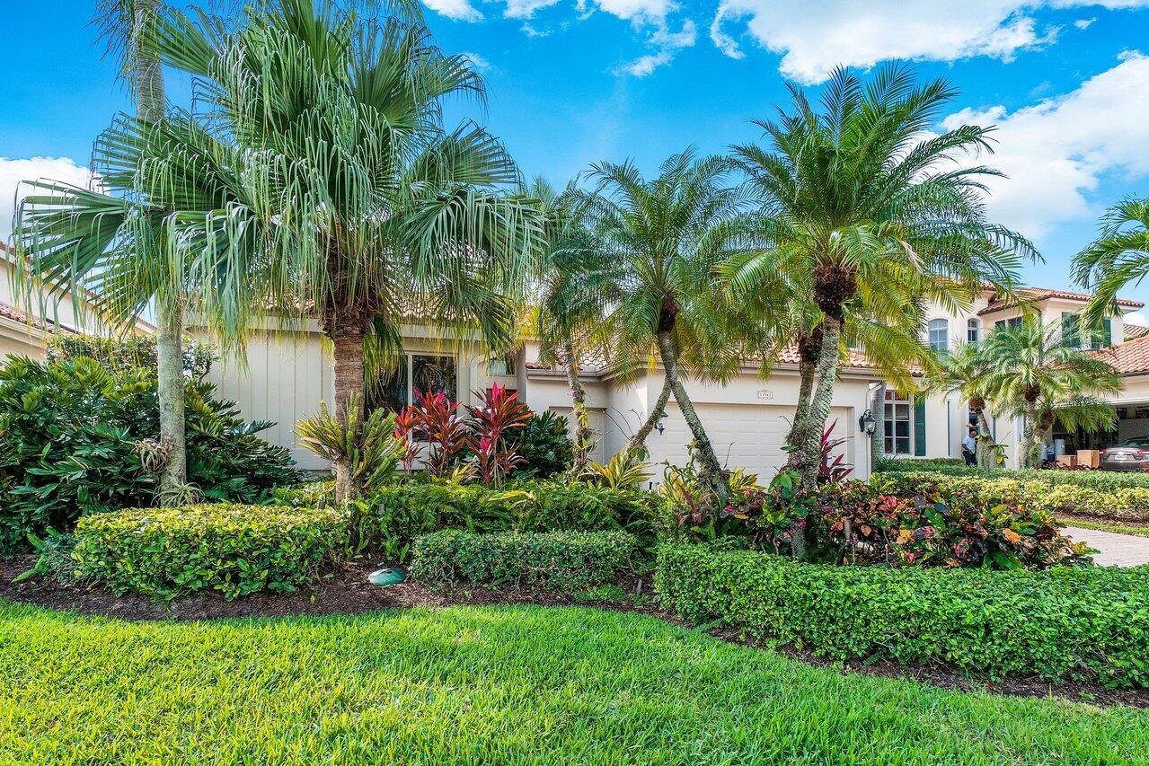 13548 Verde Drive Palm Beach Gardens, FL 33410 - Photo 42 of 43 a front view of a house with a garden