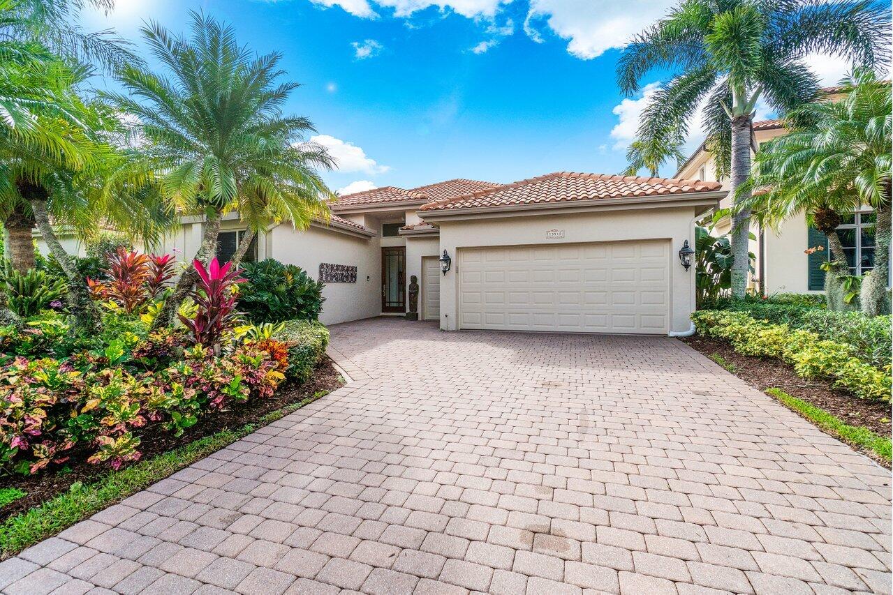 13548 Verde Drive Palm Beach Gardens, FL 33410 - Photo 43 of 43 a front view of a house with a garden