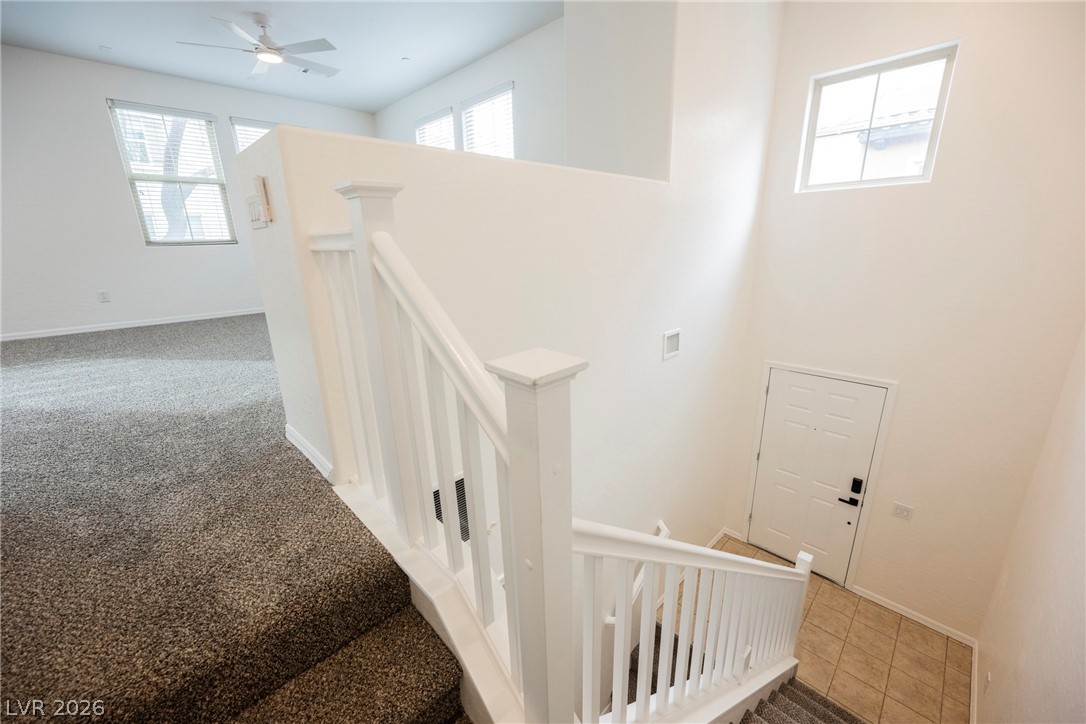 4650 Ranch House Road, Unit 64 North Las Vegas, NV 89031 - Photo 9 of 39 This interior image showcases an elegant entryway with stairs leading to an open living space.