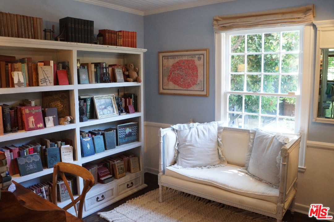 919 Rivas Canyon Road Pacific Palisades, CA 90272 - Photo 12 of 43 a living room with furniture and a book shelf
