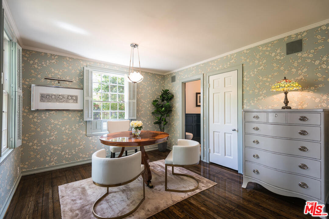 919 Rivas Canyon Road Pacific Palisades, CA 90272 - Photo 13 of 43 a dining room with furniture a window and a rug