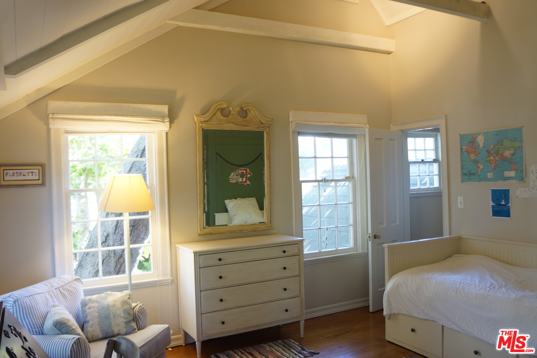 919 Rivas Canyon Road Pacific Palisades, CA 90272 - Photo 19 of 43 a bedroom with a bed and a window