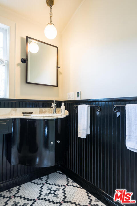 919 Rivas Canyon Road Pacific Palisades, CA 90272 - Photo 20 of 43 a bathroom with a sink and a mirror