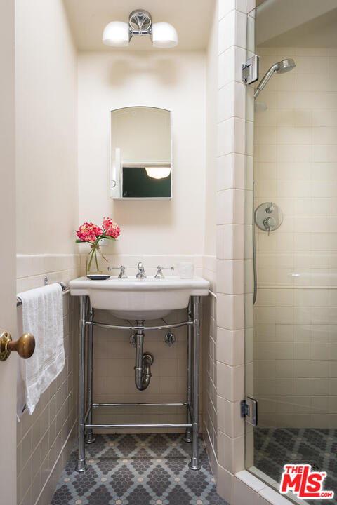919 Rivas Canyon Road Pacific Palisades, CA 90272 - Photo 23 of 43 a bathroom with a sink and mirror