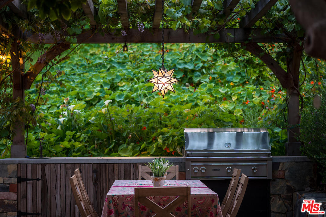 919 Rivas Canyon Road Pacific Palisades, CA 90272 - Photo 32 of 43 a view of house with backyard outdoor seating and green space