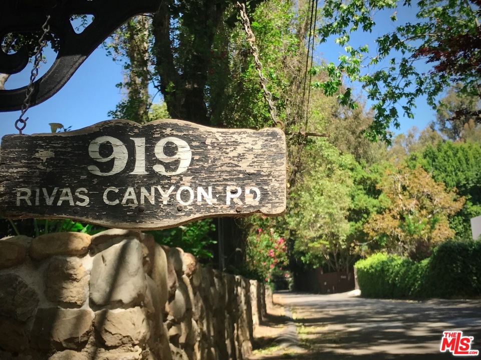919 Rivas Canyon Road Pacific Palisades, CA 90272 - Photo 43 of 43 a view of outdoor space with signage and flags