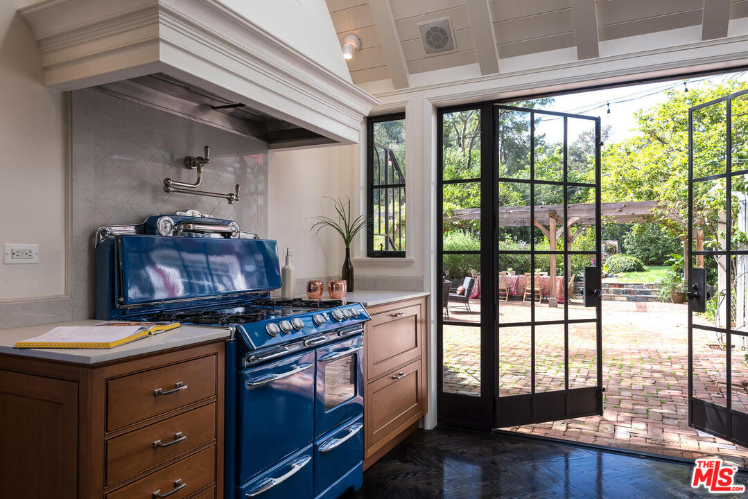 919 Rivas Canyon Road Pacific Palisades, CA 90272 - Photo 10 of 43 a kitchen with a stove and wooden floor