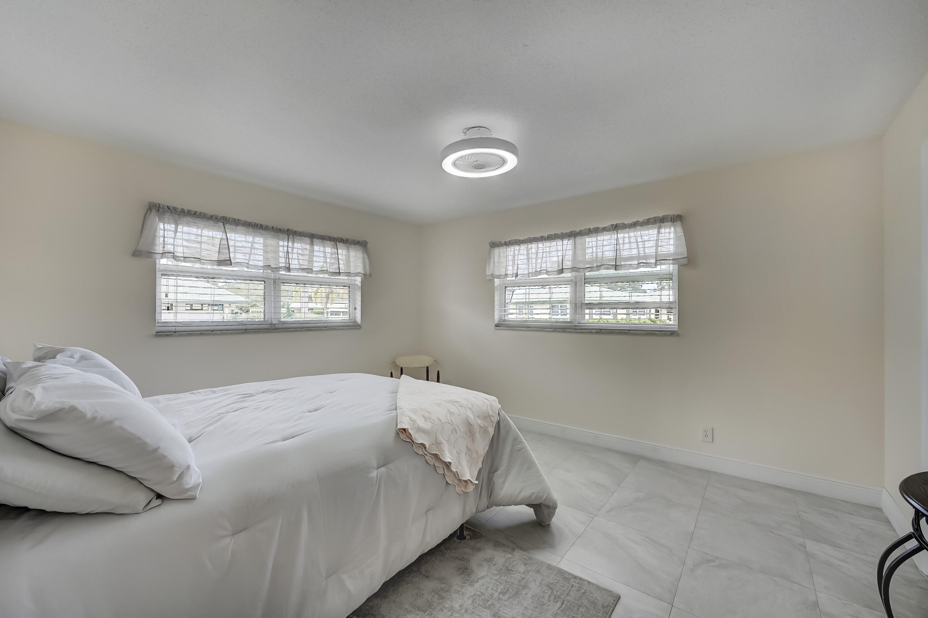 227 Cardinal Lane Delray Beach, FL 33445 - Photo 14 of 38 a bedroom with a bed and a window