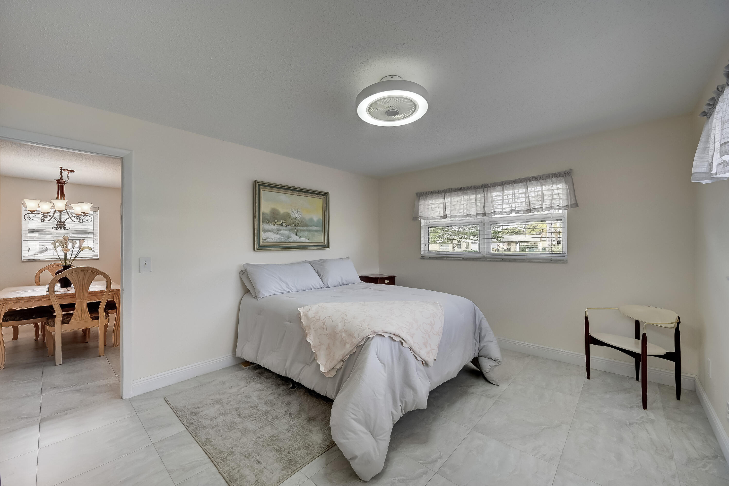 227 Cardinal Lane Delray Beach, FL 33445 - Photo 15 of 38 a bedroom with a bed and a table