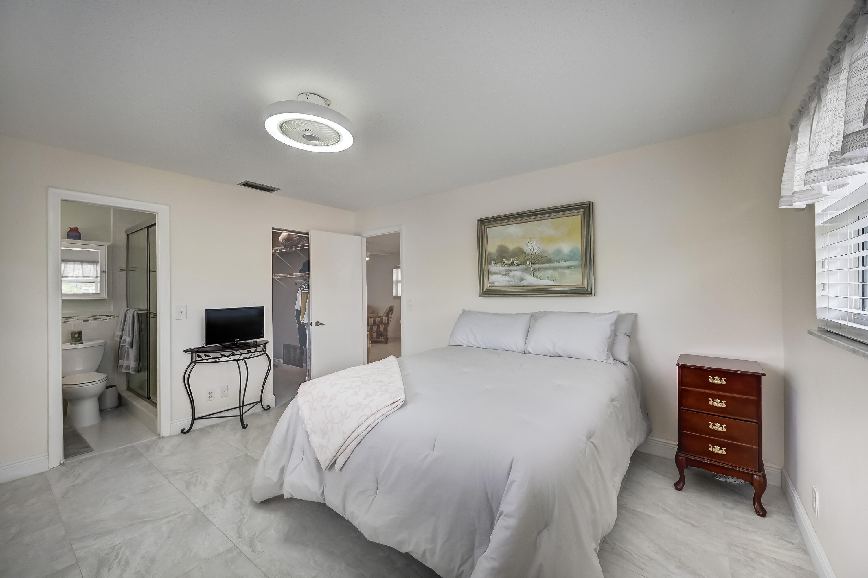 227 Cardinal Lane Delray Beach, FL 33445 - Photo 16 of 38 a bedroom with a bed and a view of kitchen