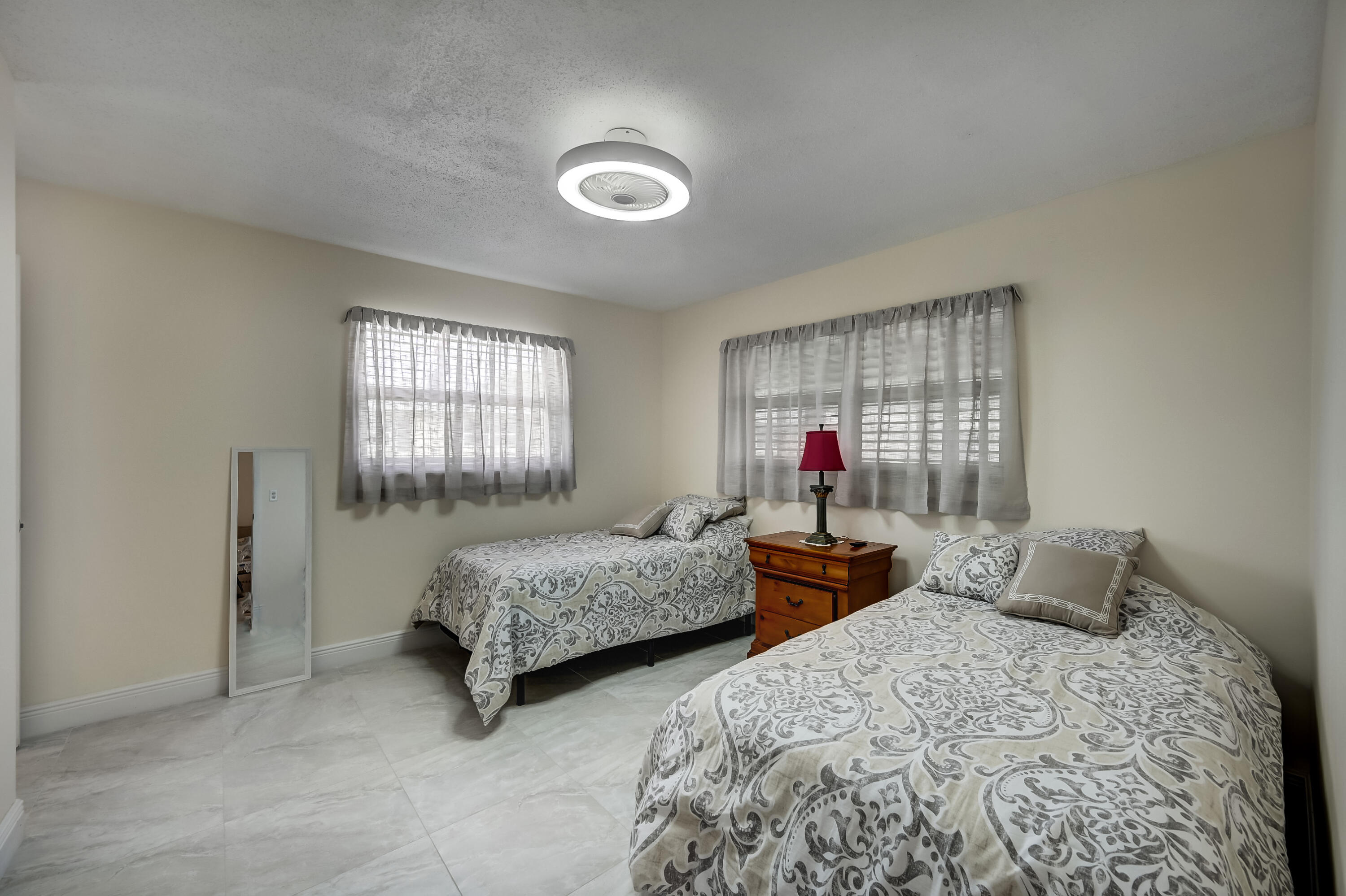 227 Cardinal Lane Delray Beach, FL 33445 - Photo 19 of 38 a bedroom with two beds and window