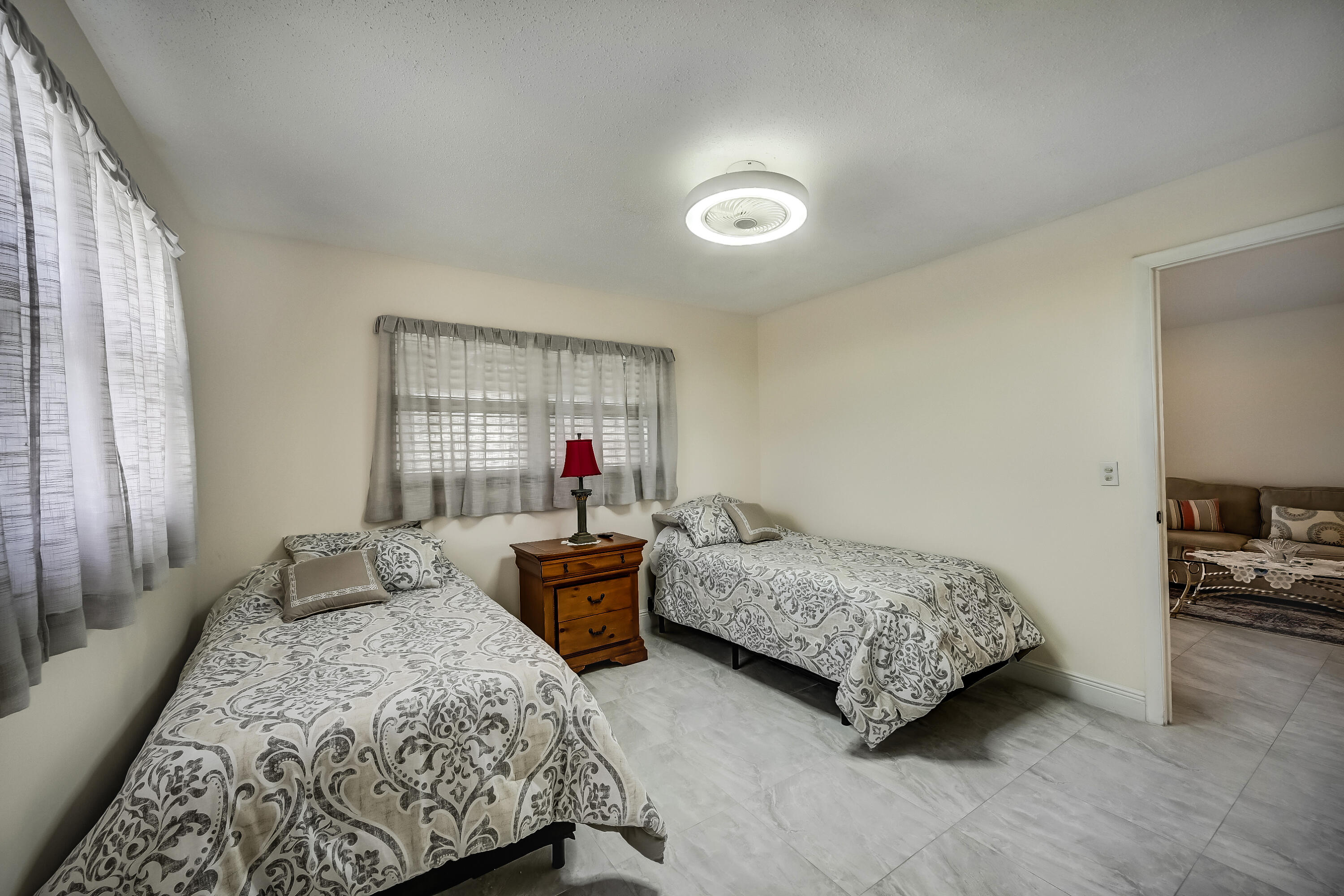 227 Cardinal Lane Delray Beach, FL 33445 - Photo 20 of 38 a bedroom with two beds and windows
