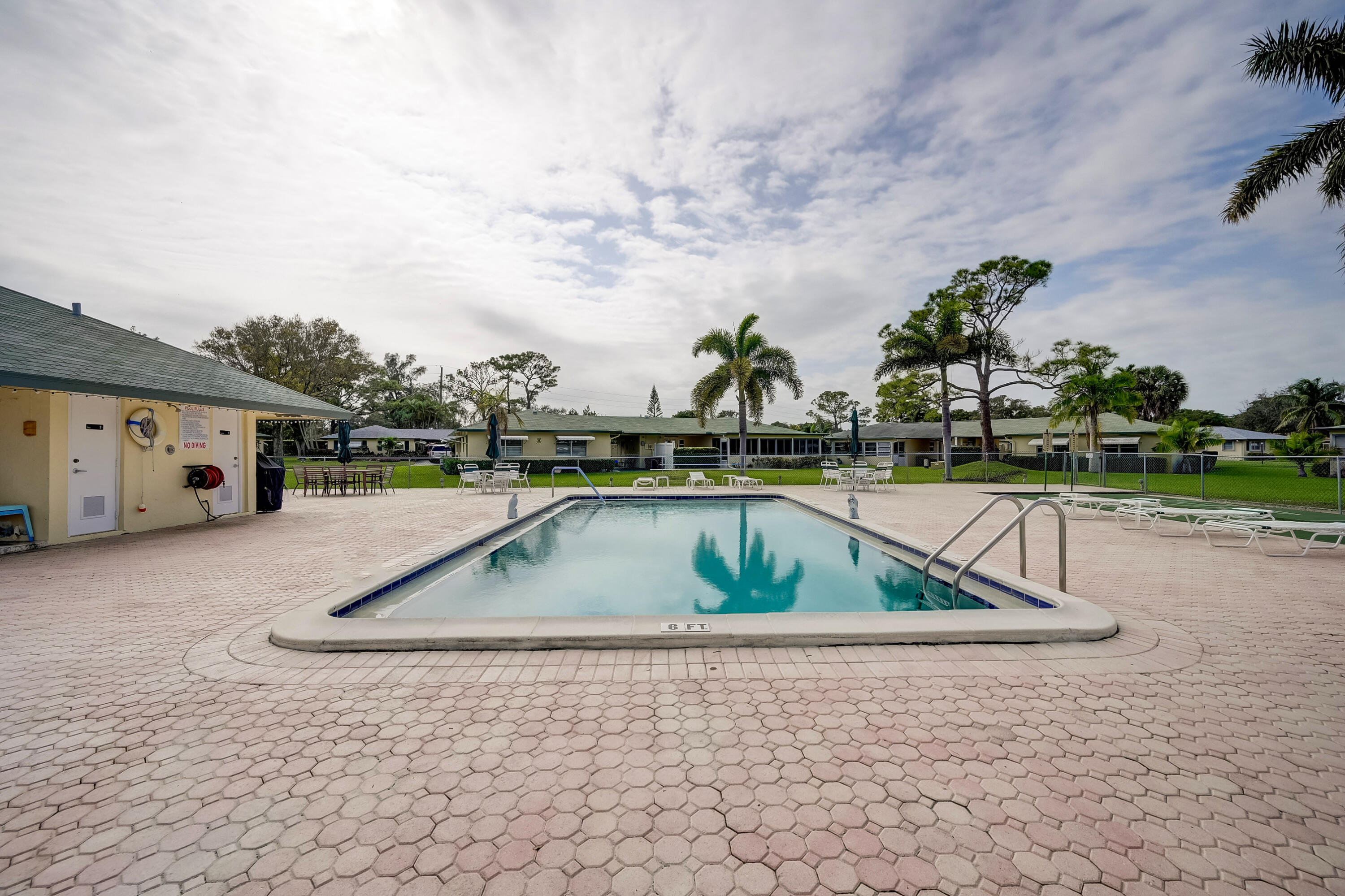 227 Cardinal Lane Delray Beach, FL 33445 - Photo 27 of 38 a view of swimming pool with outdoor seating and plants