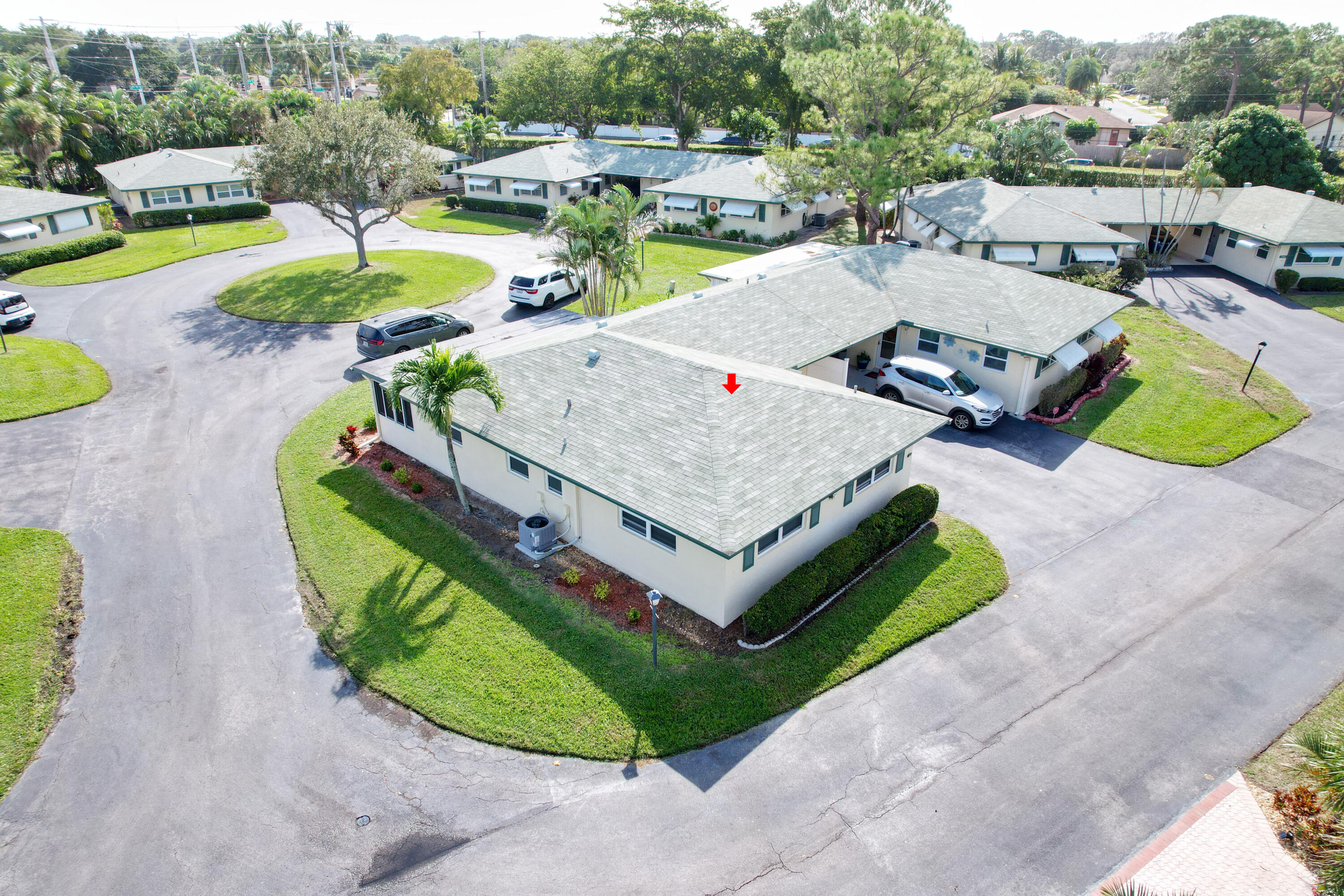 227 Cardinal Lane Delray Beach, FL 33445 - Photo 33 of 38 a view of a swimming pool with lawn chairs and a fire pit