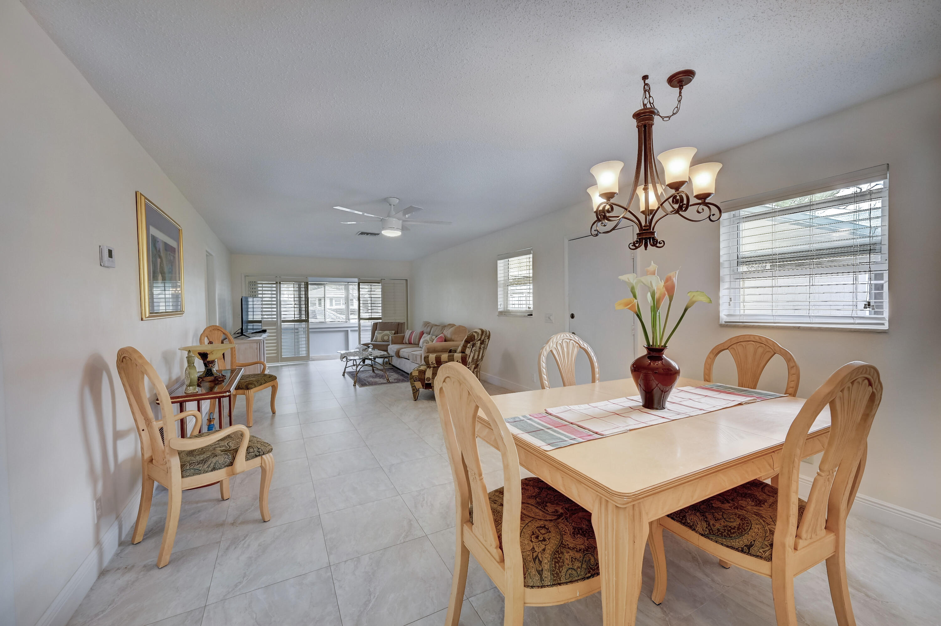 227 Cardinal Lane Delray Beach, FL 33445 - Photo 7 of 38 a view of a dining room with furniture and chandelier