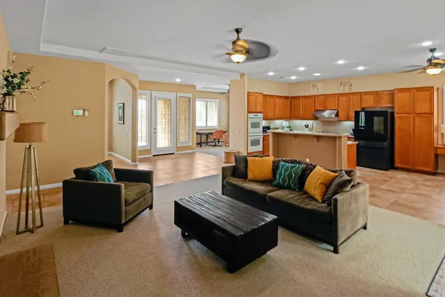 a living room with furniture and kitchen view
