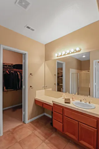a bathroom with a sink double vanity and a shower