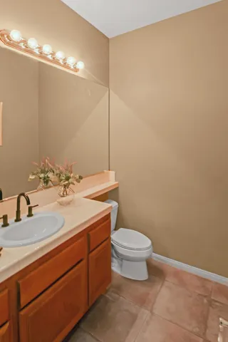 a bathroom with a sink a toilet and mirror