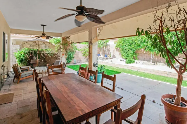 a dining room with furniture a garden and patio