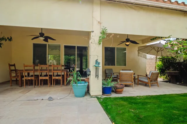 a view of a house with backyard porch and sitting area