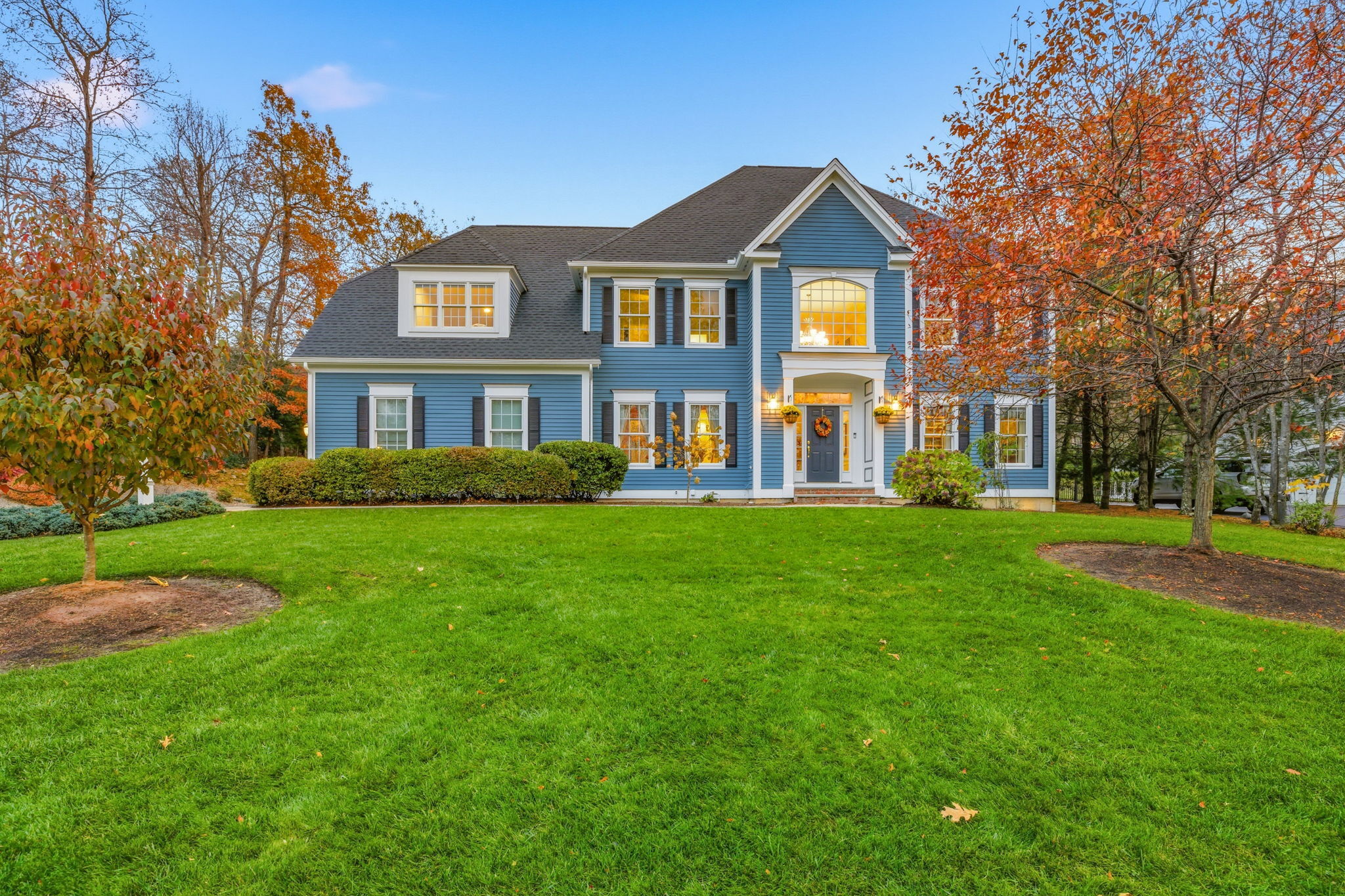 a front view of a house with a garden