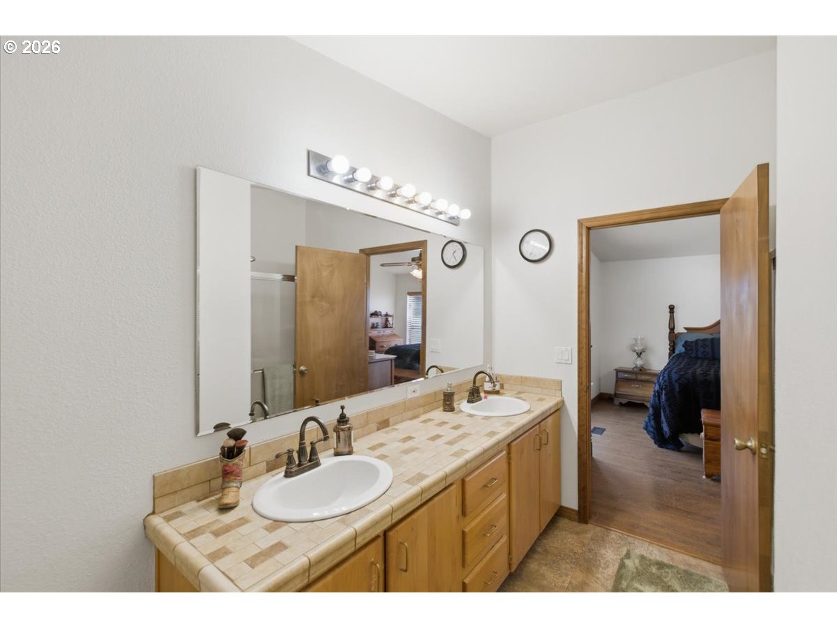 35377 Ede Road Lebanon, OR 97355 - Photo 21 of 48 a en suite bathroom with a granite countertop sink and a mirror