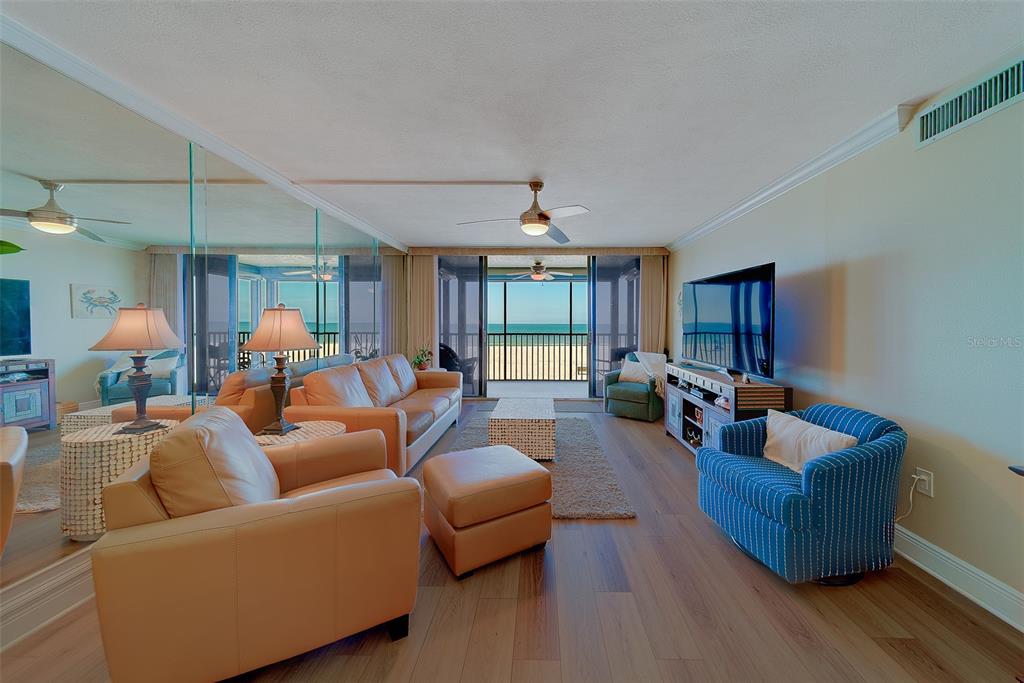 18304 Gulf Boulevard, Unit 102 Redington Shores, FL 33708 - Photo 15 of 55 a living room with furniture and wooden floor