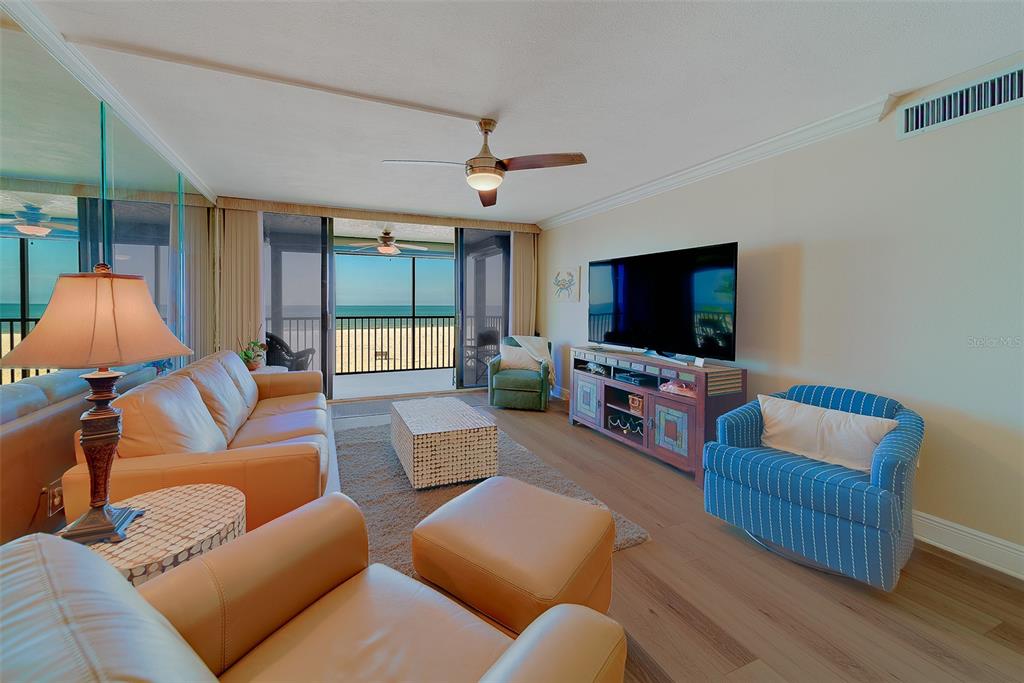 18304 Gulf Boulevard, Unit 102 Redington Shores, FL 33708 - Photo 17 of 55 a living room with furniture and a flat screen tv