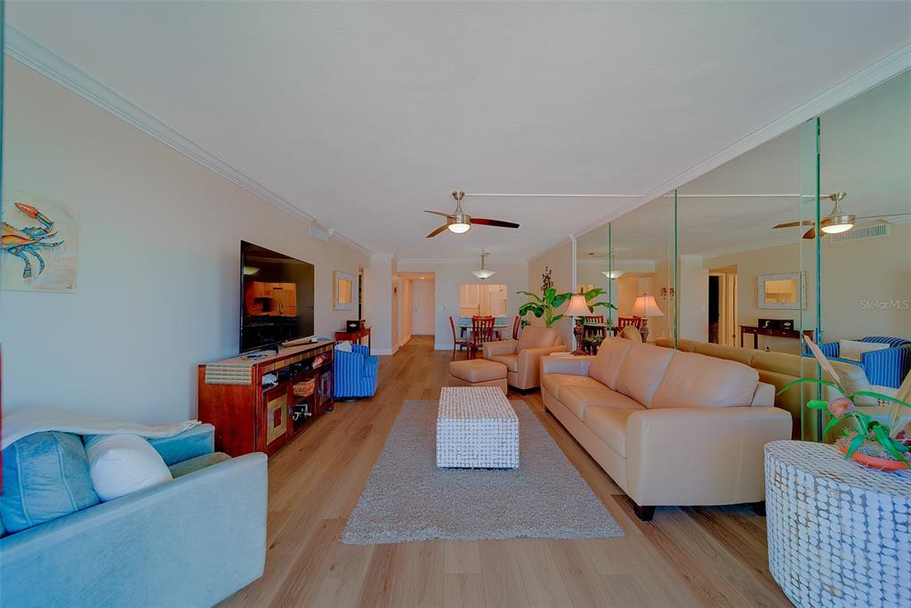 18304 Gulf Boulevard, Unit 102 Redington Shores, FL 33708 - Photo 19 of 55 a living room with furniture and a flat screen tv