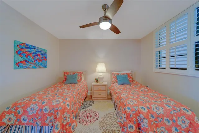 a bedroom with two beds and a chandelier