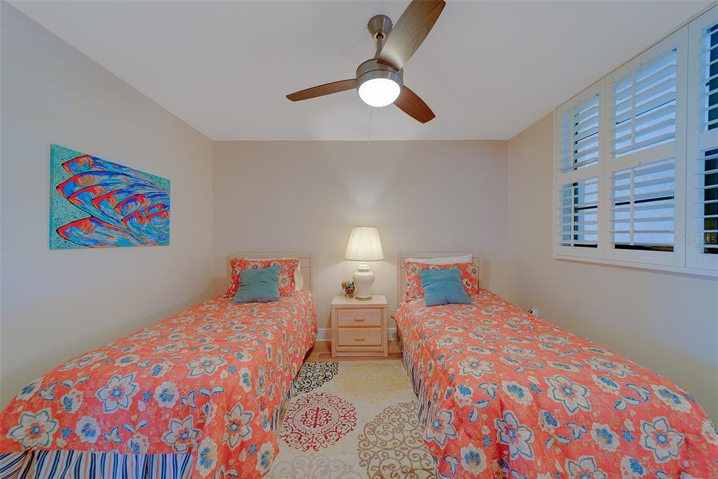 18304 Gulf Boulevard, Unit 102 Redington Shores, FL 33708 - Photo 24 of 55 a bedroom with two beds and painting on the wall