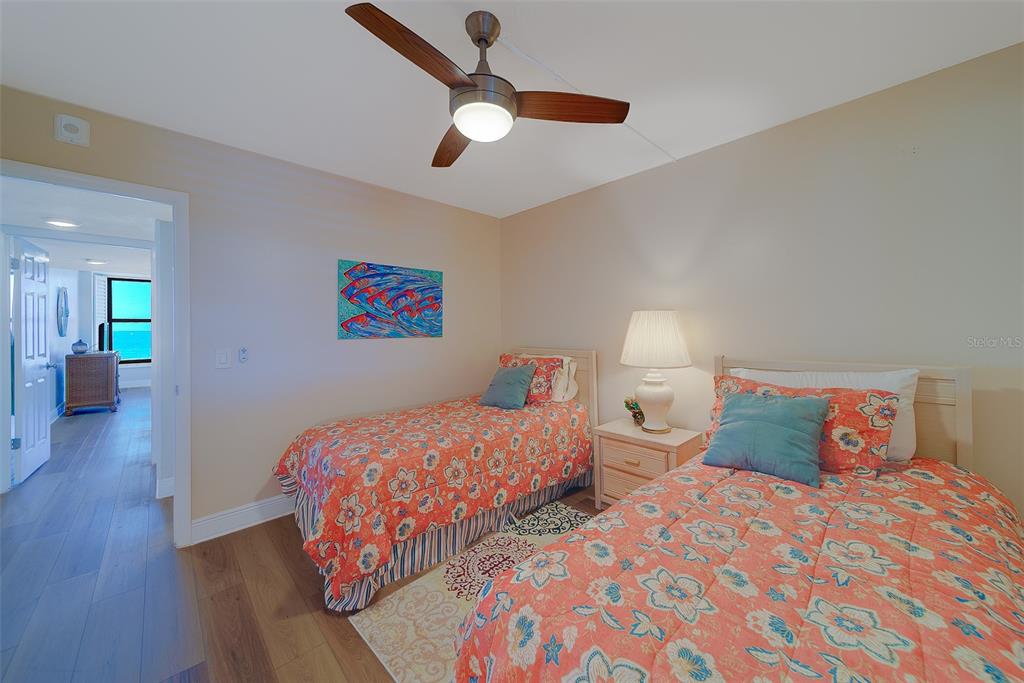 18304 Gulf Boulevard, Unit 102 Redington Shores, FL 33708 - Photo 25 of 55 a bedroom with two beds and painting on the wall