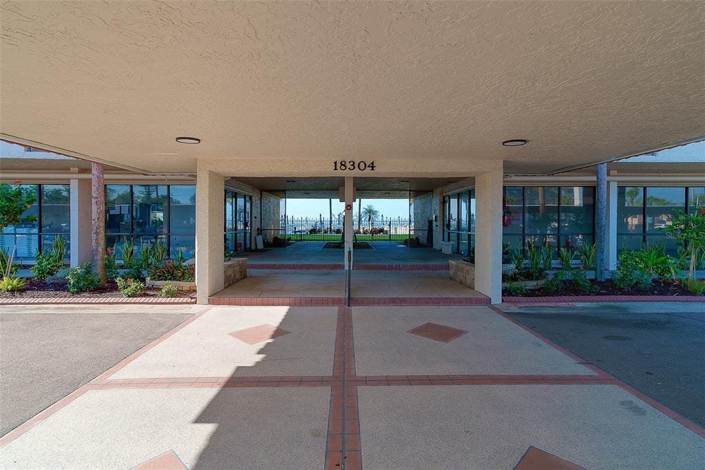 18304 Gulf Boulevard, Unit 102 Redington Shores, FL 33708 - Photo 28 of 55 a patio with yard and glass door