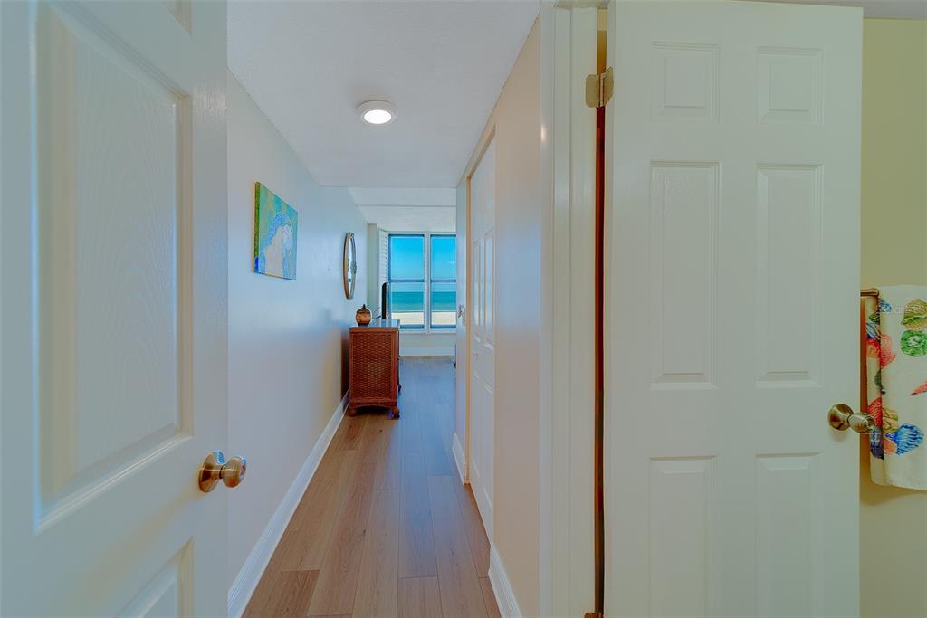 18304 Gulf Boulevard, Unit 102 Redington Shores, FL 33708 - Photo 29 of 55 a view of a hallway with wooden floor and closet