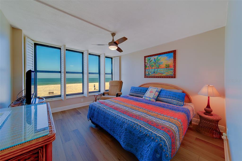 18304 Gulf Boulevard, Unit 102 Redington Shores, FL 33708 - Photo 32 of 55 a bedroom with a bed and a large window