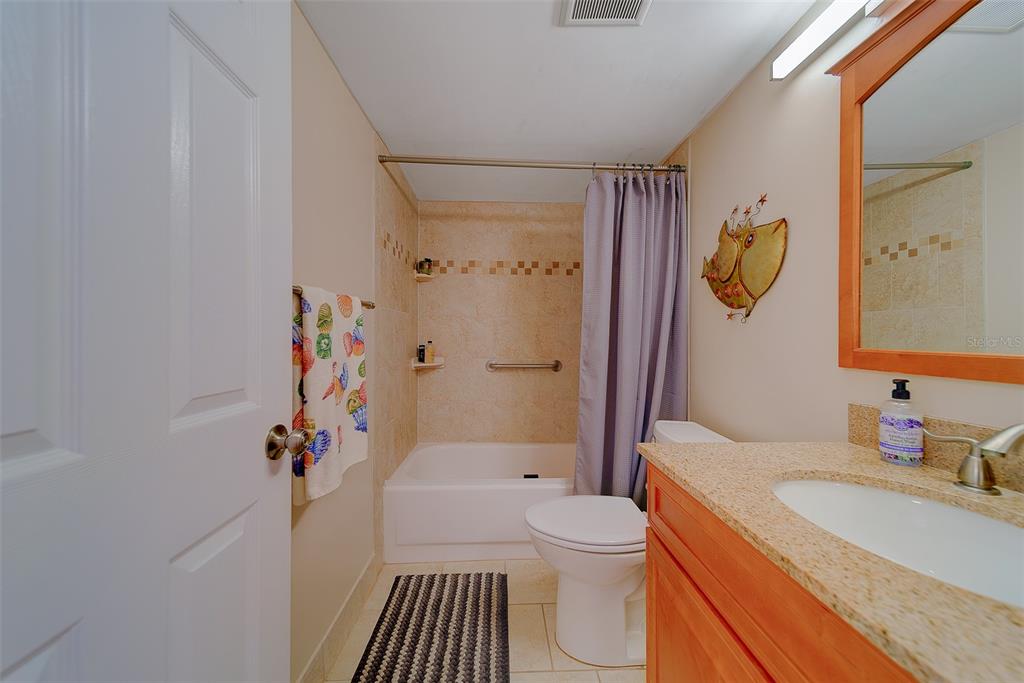 18304 Gulf Boulevard, Unit 102 Redington Shores, FL 33708 - Photo 33 of 55 a bathroom with a sink a toilet and shower