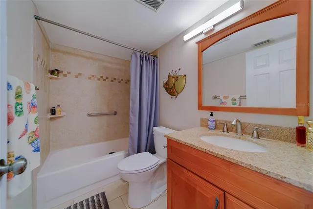 a bathroom with a sink vanity mirror and toilet