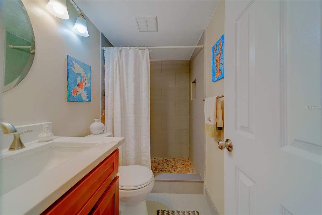 18304 Gulf Boulevard, Unit 102 Redington Shores, FL 33708 - Photo 35 of 55 a bathroom with a sink and a mirror